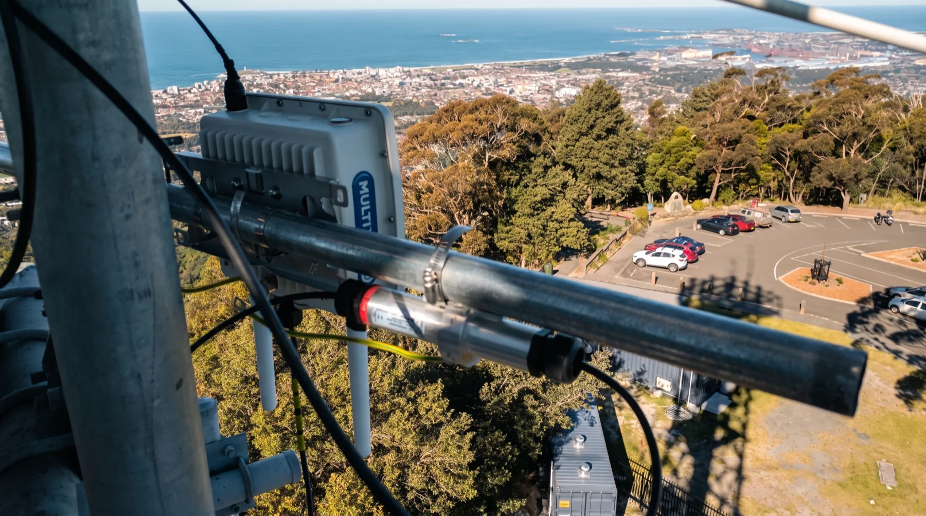 A Meshed LoRaWAN gateway installed on a hilltop overlooking an Australian coastal city and its surrounding region
