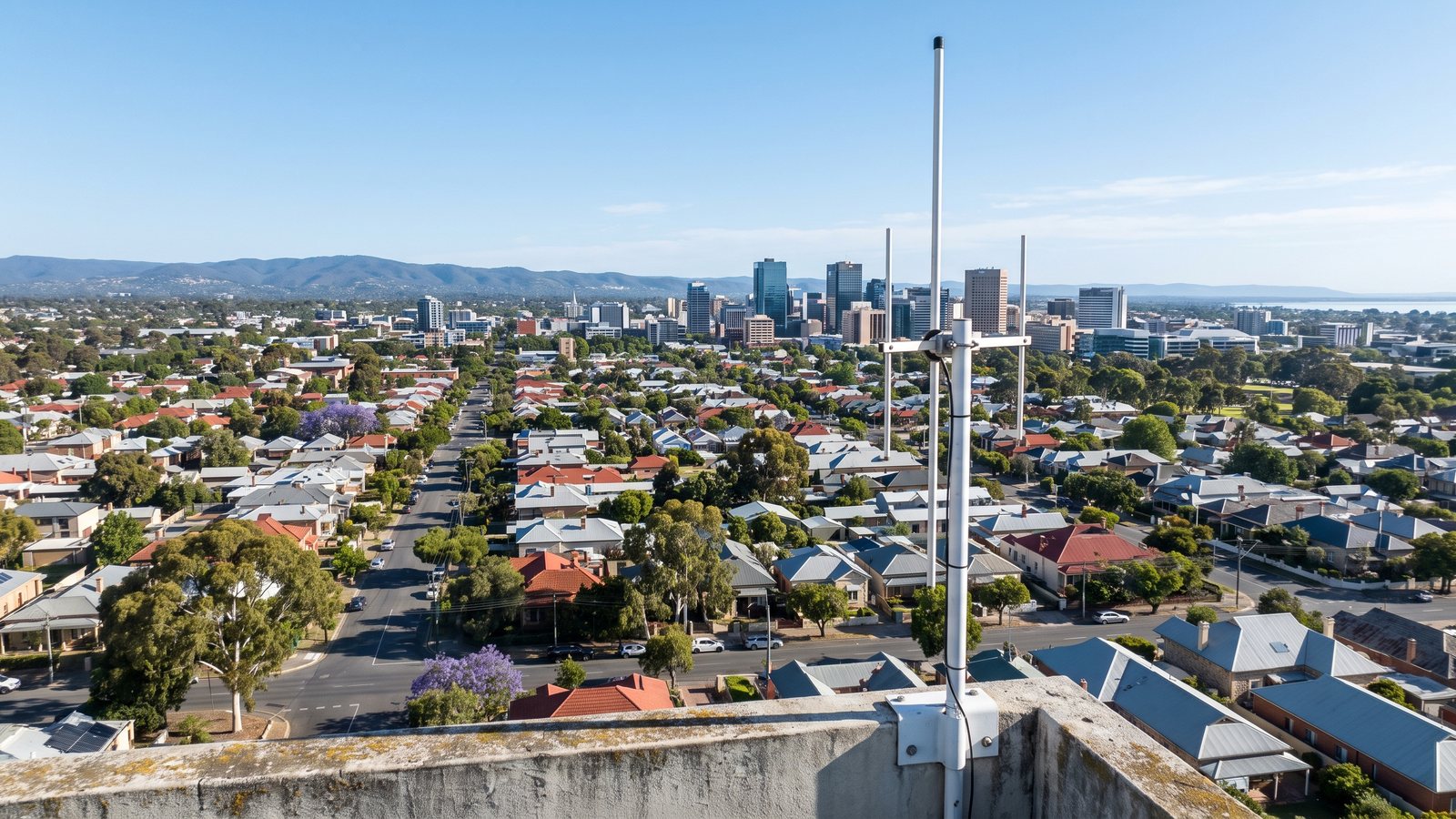 A rooftop LoRaWAN antenna overlooking Adelaide's suburbs, city skyline and hills