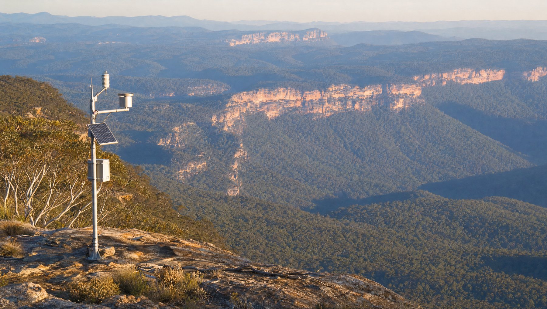 A solar-powered sensing station on a ridge above Australian bushland