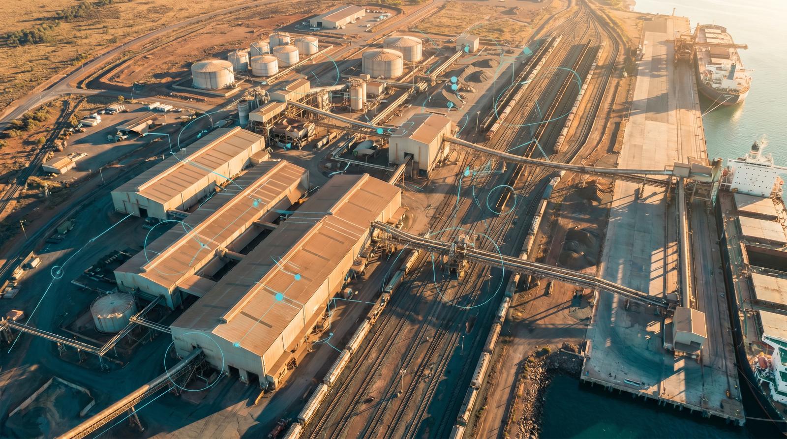 An aerial view of an Australian industrial precinct with port and rail infrastructure linked by a managed sensor network.