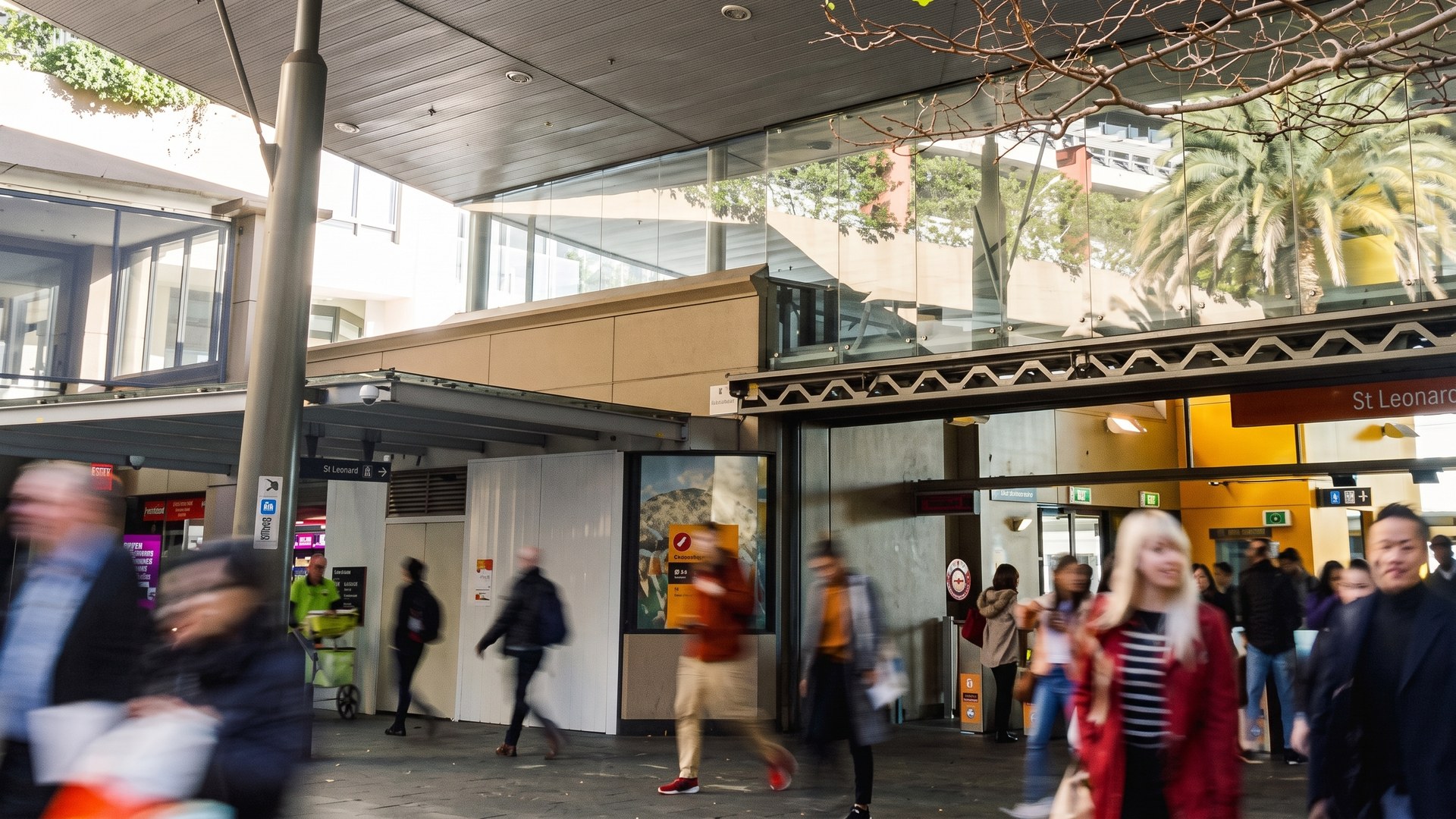 Commuters moving through a railway station concourse